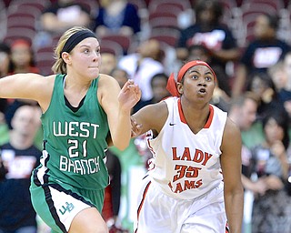 Jeff Lange | The Vindicator  West Branch's Pavin Heath (21) and Tanaya Beacham (35) both stare down a loose ball as they both race for possession late in the second half of their DII state semifinal game, Friday night in Columbus.