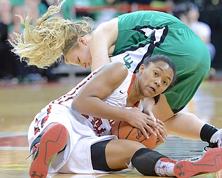 Jeff Lange | The Vindicator  Toledo Rogers' Breylnn Hampton-Bey maintains control of the ball as West Branch's Melinda Trimmer attempts to grab the ball away in the first quarter of their DII state semifinal game, Friday night in Columbus.