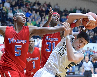 Jeff Lange | The Vindicator  Ursuline's Armon Nasseri (33) falls as he battles for possession with Vikings' defenders Derek Pardon (5) and Carlton Bragg (31) in the third quarter of their DIII regional final game, Saturday night in Canton. The Irish fell to VASJ 66 to 45.