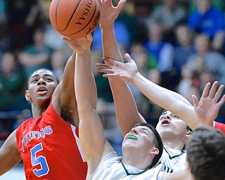 Jeff Lange | The Vindicator  Stretching out for a rebound are Ursuline's Vito Penza (bottom), Armon Nasseri (back) and VASJ's Derek Pardon (5) during first half action in their Saturday-night regional championship game in Canton.