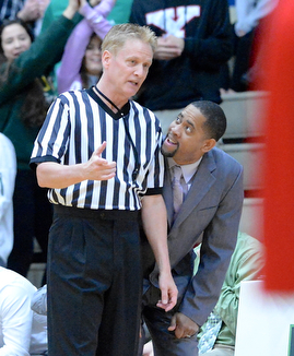 Jeff Lange | The Vindicator  Ursuline's head coach Keith Gunther (right) looks to an official for explanation of a call made in the first half of their regional final against VASJ, Saturday, March 21, 2015 in Canton.
