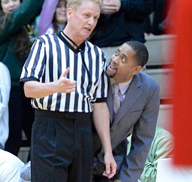 Jeff Lange | The Vindicator  Ursuline's head coach Keith Gunther (right) looks to an official for explanation of a call made in the first half of their regional final against VASJ, Saturday, March 21, 2015 in Canton.