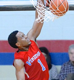 Jeff Lange | The Vindicator  Villa Angela-St.Joseph's Brian Parker (1) looks as he slams the ball through the hoop for two in the third quarter of the Vikings' regional championship game against Ursuline, Saturday night in Canton.