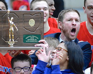 Jeff Lange | The Vindicator  Villa Angela-St. Joseph head coach Babe Kwasniak (right) lets out a shout of joy as he displays the Division III regional championship plaque after defeating the Ursuline Irish 66-45, Saturday night at the Canton Fieldhouse.
