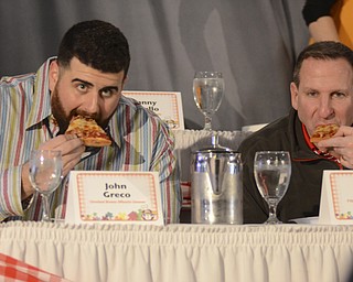 Katie Rickman | The Vindicator.John Greco, Offensive Lineman for the Cleveland Browns and Bo Pelini, head football coach at Youngstown State University test pizza during the Mahoning Valley Pizza Cook-Off benefit for Potential Development Schools at Mr. Anthony's in Boardman on Sunday, March 8, 2015.