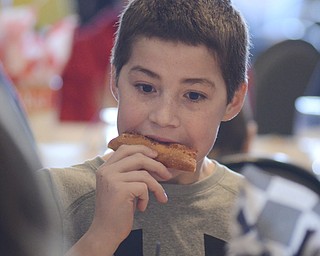 Katie Rickman | The Vindicator.Luke Blasko 12 of North Lima enjoys pizza at the Mahoning Valley Pizza Cook-Off benefit for Potential Development Schools at Mr. Anthony's in Boardman on Sunday, March 8, 2015.