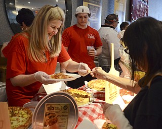 Katie Rickman | The Vindicator .Cindy Cerimele of Canfield's Belleria serves Marlane Joyce of Cornersburgh pizza during the Mahoning Valley Pizza Cook-Off benefit for Potential Development Schools at Mr. Anthony's in Boardman on Sunday, March 8, 2015.