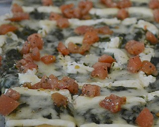 Katie Rickman | The Vindicator.Many variations of pizza was available at the Mahoning Valley Pizza Cook-Off benefit for Potential Development Schools at Mr. Anthony's in Boardman on Sunday, March 8, 2015. Featured here is a tomato, cheese and spinach pizza.