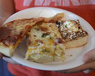 Katie Rickman | The Vindicator.A man picks out three types of pizza to try out  at the Mahoning Valley Pizza Cook-Off benefit for Potential Development Schools at Mr. Anthony's in Boardman on Sunday, March 8, 2015.