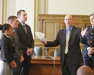        ROBERT K. YOSAY  | THE VINDICATOR.. With Chief Robin Lees in the backround -  Mayor John A McNally --  talks about the new officers ..Sworn in was Jeshalia Dunkle, 22, of Youngstown; Travis Sheely, 24, of Mineral Ridge; and Michael Conway, 24, of Niles.