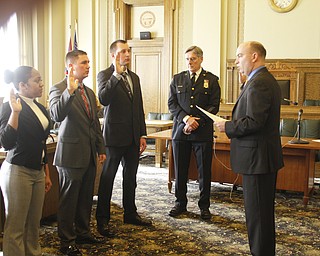        ROBERT K. YOSAY  | THE VINDICATOR.. With Chief Robin Lees in the backround -  Mayor John A McNally --  talks about the new officers ..Sworn in was Jeshalia Dunkle, 22, of Youngstown; Travis Sheely, 24, of Mineral Ridge; and Michael Conway, 24, of Niles.
