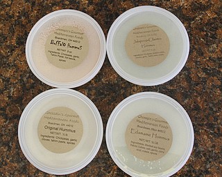        ROBERT K. YOSAY  | THE VINDICATOR..Melissa Poland and her four types of humus by the famous Deli area...The local Mediterranean deli, bakery and caterer, GhossainÕs on the citys southside - turned 45 this year. Over the past few years, the company has expanded its catering side of the business and makes hummus for local schools...