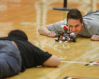        ROBERT K. YOSAY  | THE VINDICATOR..Perfect line up as  Travis Bernard (back to Camer and WIlliam Stephenson both seniors at South Range... The 18th annual Northeast Ohio Robotics Education Program Competition took place at Beeghly Center at YSU.Eighteen teams from 11 schools from Mahoning, Trumbull counties competed,..