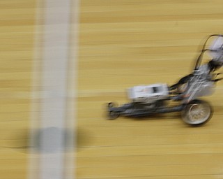        ROBERT K. YOSAY  | THE VINDICATOR..Zooming by- as the robot passes over the end line before changing direction and heading back . .. The 18th annual Northeast Ohio Robotics Education Program Competition took place at Beeghly Center at YSU.Eighteen teams from 11 schools from Mahoning, Trumbull counties competed,..