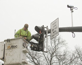        ROBERT K. YOSAY  | THE VINDICATOR..A new traffic system is being set up in Canfield as Cornerstone Electric in Salem installs the lights w traffic sensors and also sensors for emergency vehicles that will trip the lights to red, the city also gets new cross walk signs.  Adam Blackwood with Cornerstone installs a new light at Main and Broad in Canfield