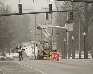        ROBERT K. YOSAY  | THE VINDICATOR..A new traffic system is being set up in Canfield as Cornerstone Electric in Salem installs the lights w traffic sensors and also sensors for emergency vehicles that will trip the lights to red, the city also gets new cross walk signs.  Adam Blackwood with Cornerstone installs a new light at Main and Broad in Canfield