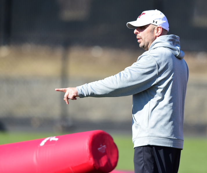 YOUNGSTOWN, OHIO - MARCH 24, 2015: Defensive line coach Carl Pelini gives instructions during individual position drills during Tuesday afternoons practice at Stambaugh Stadium. (Photo by David Dermer/Youngstown Vindicator)
