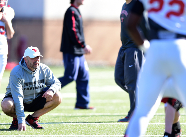 YOUNGSTOWN, OHIO - MARCH 24, 2015: Defensive line coach Carl Pelini watches team drills from behind the play during Tuesday afternoons practice at Stambaugh Stadium. (Photo by David Dermer/Youngstown Vindicator)