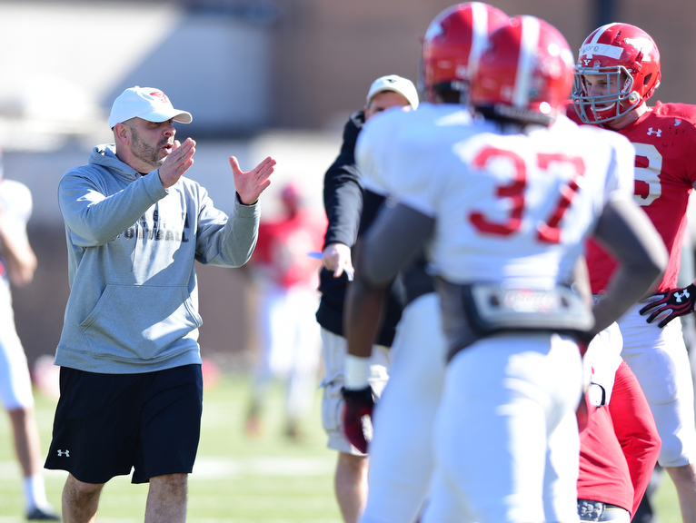 YOUNGSTOWN, OHIO - MARCH 24, 2015: Defensive line coach Carl Pelini gives instructions to a player during team drills during Tuesday afternoons practice at Stambaugh Stadium. (Photo by David Dermer/Youngstown Vindicator)