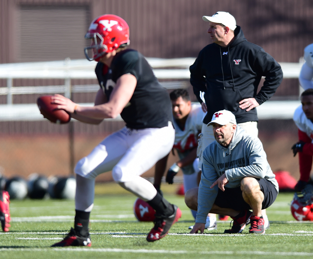 YOUNGSTOWN, OHIO - MARCH 24, 2015: Defensive line coach Carl Pelini watches as Ricky Davis #12 drops back to pass uring Tuesday afternoons practice at Stambaugh Stadium. (Photo by David Dermer/Youngstown Vindicator)