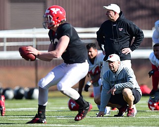 YOUNGSTOWN, OHIO - MARCH 24, 2015: Defensive line coach Carl Pelini watches as Ricky Davis #12 drops back to pass uring Tuesday afternoons practice at Stambaugh Stadium. (Photo by David Dermer/Youngstown Vindicator)