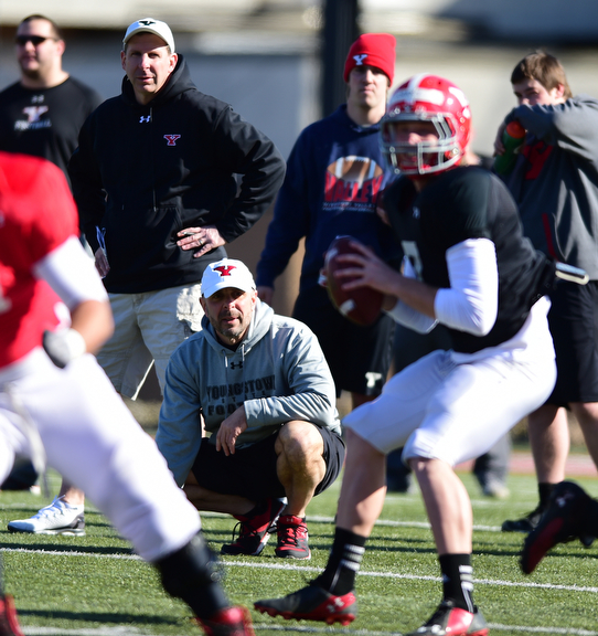 YOUNGSTOWN, OHIO - MARCH 24, 2015: Defensive line coach Carl Pelini & head coach Bo Pelini of YSU watches as Hunter Wells #6 drops back to pass during Tuesday afternoons practice at Stambaugh Stadium. (Photo by David Dermer/Youngstown Vindicator)
