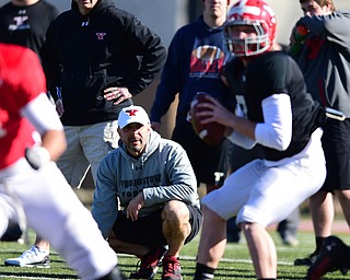 YOUNGSTOWN, OHIO - MARCH 24, 2015: Defensive line coach Carl Pelini & head coach Bo Pelini of YSU watches as Hunter Wells #6 drops back to pass during Tuesday afternoons practice at Stambaugh Stadium. (Photo by David Dermer/Youngstown Vindicator)