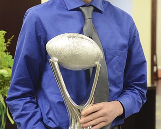 Katie Rickman | The Vindicator.Colin Burdette of Hubbard holds the Heart of a Champion Award on March 12, 2015.