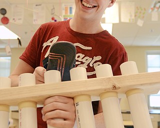 Katie Rickman | The Vindicator.Tommy Carnes, a senior at Jackson-Milton High School plays a song using a handmade musical instrument that he and other classmates made for a physics competition.
