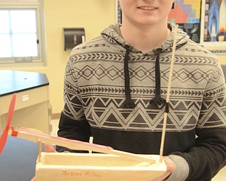 Katie Rickman | The Vindicator.Jarrod Kegley holds a handmade boat that he made along wih Caleb Spalding for a physics competition.  The students designs won them several awards.