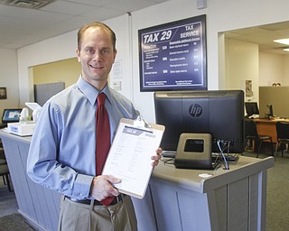        ROBERT K. YOSAY  | THE VINDICATOR..Tax 29/ Andrew Reigstad is busy as the tax season hits the home stretch- in his poland office on 224