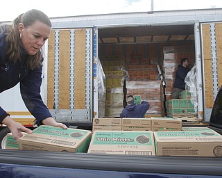        ROBERT K. YOSAY  | THE VINDICATOR..yep thin mints as Carolyn Crawford  of fowler and troop 80379- picks up some of the 1800 boxes her troop has sold..Girl Scout cookies by the thousands of boxes, arrived via 4 semi-trucks Friday  at W. D. Packard Music Hall here and are arriving sat at St. Michael Parish in Canfield to be picked up by local Girl Scout leaders for distribution to their troop members.