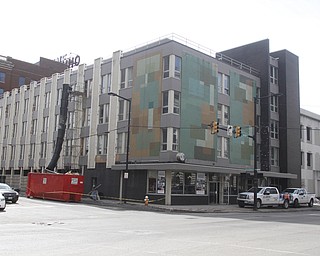        ROBERT K. YOSAY  | THE VINDICATOR..The Legal Arts Building - and The Hub Restaurant  on Market and Boardman felt the ravages of winter as a roof drain pipe froze sending water throughout the building. A worker caries wet drywall to  a dumpster
