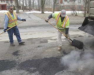        ROBERT K. YOSAY  | THE VINDICATOR..filling and leveling are  Abe Hammond --Coy Serdich with Mahoning County Engineers on Indianola Rd in Boardman..Day-reporting inmates supervised by Mahoning County deputies will once again help the county engineerÕs crews patch potholes..This year, however, the work will be done with the consent of Teamsters Union Local 377, which represents the county engineerÕs road maintenance employees.