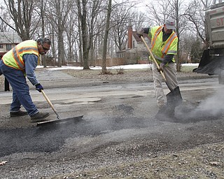        ROBERT K. YOSAY  | THE VINDICATOR..filling and leveling are  Abe Hammond --Coy Serdich with Mahoning County Engineers on Indianola Rd in Boardman..Day-reporting inmates supervised by Mahoning County deputies will once again help the county engineerÕs crews patch potholes..This year, however, the work will be done with the consent of Teamsters Union Local 377, which represents the county engineerÕs road maintenance employees.