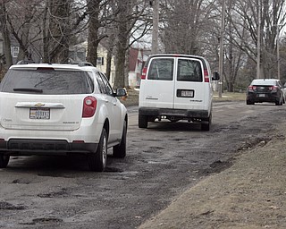        ROBERT K. YOSAY  | THE VINDICATOR..drivers on Indianola Rd. in Boardman drive anywhere they can to avoid the many many many many potholes in a stretch between euclid  Blvd and Montrose ave.Day-reporting inmates supervised by Mahoning County deputies will once again help the county engineerÕs crews patch potholes..This year, however, the work will be done with the consent of Teamsters Union Local 377, which represents the county engineerÕs road maintenance employees.