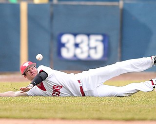 NILES, OHIO - MARCH 25, 2015: Left fielder Jason Shirley #20 of YSU dives unsuccessfully for the baseball allowing Pitt base runners to advance during the top of the 4th inning during Wednesday afternoons game at Eastwood Field. (Photo by David Dermer/Youngstown Vindicator)