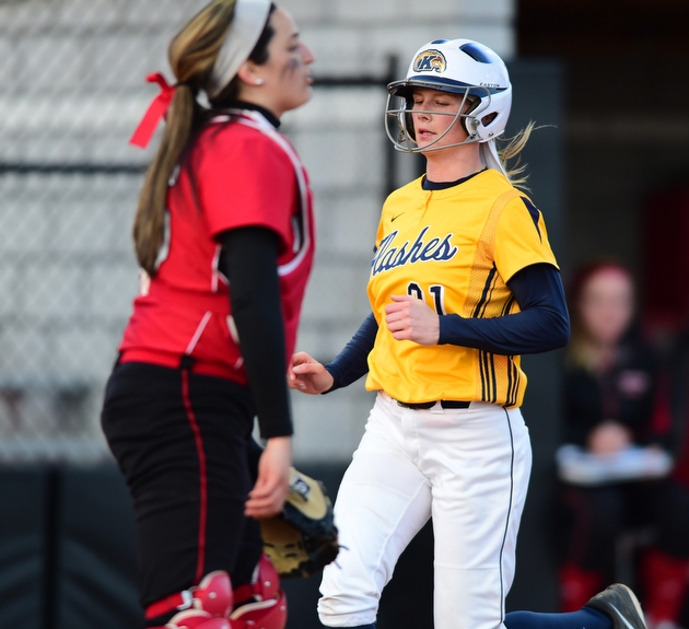 YOUNGSTOWN, OHIO - MARCH 25, 2015: Lauren Kesterson #21 of Kent State scores a KSU run after stepping on home plate behind catcher Maria Lacatena #15 of YSU in the top of the 3rd inning during game 2 of a doubleheader Wednesday night at the YSU Softball Complex. (Photo by David Dermer/Youngstown Vindicator)