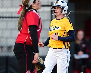 YOUNGSTOWN, OHIO - MARCH 25, 2015: Lauren Kesterson #21 of Kent State scores a KSU run after stepping on home plate behind catcher Maria Lacatena #15 of YSU in the top of the 3rd inning during game 2 of a doubleheader Wednesday night at the YSU Softball Complex. (Photo by David Dermer/Youngstown Vindicator)