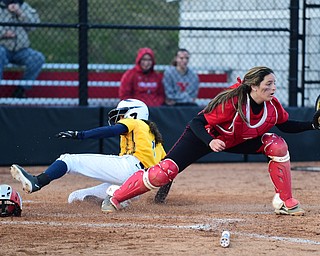 YOUNGSTOWN, OHIO - MARCH 25, 2015: Catcher Maria Lacatena #15 of YSU keeps her foot on the bag to force out base runner Dani Ramos #1 of Kent State for the 1st out in the top of the 3rd inning during game 2 of a doubleheader Wednesday night at the YSU Softball Complex. (Photo by David Dermer/Youngstown Vindicator)