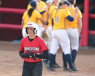 YOUNGSTOWN, OHIO - MARCH 25, 2015: Base runner Miranda Castiglione #17 of YSU walks to the dugout after grounding out to end the ball game while Kent State players celebrate behind her after game 1 of a doubleheader Wednesday night at the YSU Softball Complex. (Photo by David Dermer/Youngstown Vindicator)