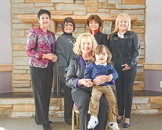 KATIE RICKMAN | THE VINDICATOR: The planning committee for the Angels of Easter Seals Spring Fashion Show and Luncheon are, seated, Lynn Sahli, Angels president, holding Jackson Diaz, 3, of Poland, and standing from left, Judy Conti, Jackie Schweiger, Carol O’Neill and Pattie Ceglie.