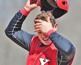 Jeff Lange | The Vindicator  YSU baserunner Shane Willoughby wipes the sweat from his brow after hitting a single in the fourth inning of the Penguins' game against UIC at Eastwood Field, Sunday, March 29, 2015.