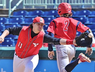Jeff Lange | The Vindicator  Youngstown first baseman Brent Gillespie (11) reaches out for a throw from third as UIC's David Cronin safely runs to first base in the top of the seventh inning of their game at Eastwood Field, Sunday, March 29, 2015.