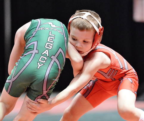Jeff Lange | The Vindicator  Jake Hughes of Beaver Local (right) works to take his opponent Brennan Warwick of Massillon Perry down by the leg during their 55.1 lb championship bout in the OAC Grade School State Wrestling Tournament, Sunday, March 29, 2015.