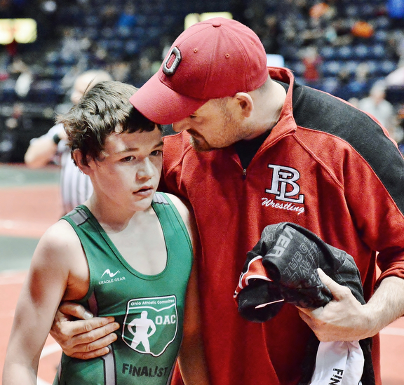 Jeff Lange | The Vindicator  Beaver Local's Brenden Severs (left) is congratulated by his father Rick after defeating his opponent Jake Niffenegger of Palmer in their 100.4 lb match during the OAC Grade School State Wrestling Tournament in Youngstown, Sunday, March 29, 2015.