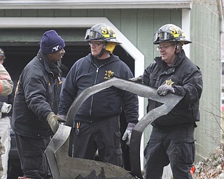        ROBERT K. YOSAY  | THE VINDICATOR..YFD Alvin Ware and State Fire Marshalls inspect part of the house where 3 people died  on Powers Way in an early morning fire..YFD, Mahoning Valley Arson Task Force, YPD detectives and State Fire Marshalls office as they investigated a fatal fire that killed Two grandparents and their 11 year old grandaughter.