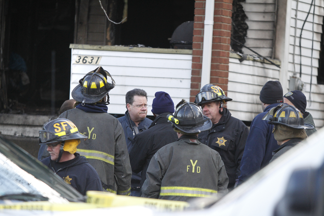        ROBERT K. YOSAY  | THE VINDICATOR...Fire Chief John O'Neil.. talks with investigators at the scene of a triple fatal and where a firefighter was injured..YFD, Mahoning Valley Arson Task Force, YPD detectives and State Fire Marshalls office as they investigated a fatal fire that killed Two grandparents and their 11 year old grandaughter.