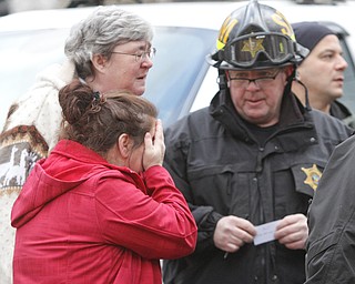        ROBERT K. YOSAY  | THE VINDICATOR.. a friend reacts as she  finds out from State fire Marshall  who all died in the fire on Powers Way in Youngstown.. YFD, Mahoning Valley Arson Task Force, YPD detectives and State Fire Marshalls office as they investigated a fatal fire that killed Two grandparents and their 11 year old grandaughter.