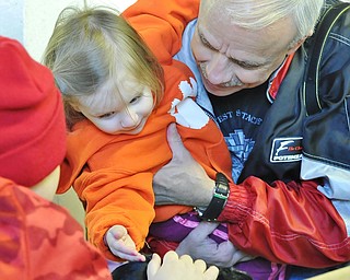Jeff Lange | The Vindicator  APRIL 4, 2015 - David Prokop of Boardman (right) lifts his granddaughter Andie Gerald so she can pet the rabbits in the barn at Mill Creek MetroParks Farm in Canfield, Saturday afternoon.
